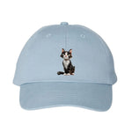 A baby blue DadHat cap featuring the #0022 printed design depicting a cat