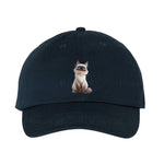 A navy DadHat cap featuring the #0025 printed design depicting a cat