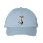 A baby blue DadHat cap featuring the #0046 printed design depicting a cat