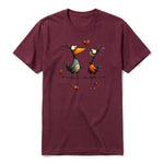 A maroon short-sleeve crewneck t-shirt for adult featuring a graphic of a quirky bird on the front.
